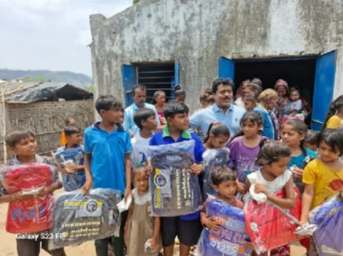 Children holding school bags outside a building
